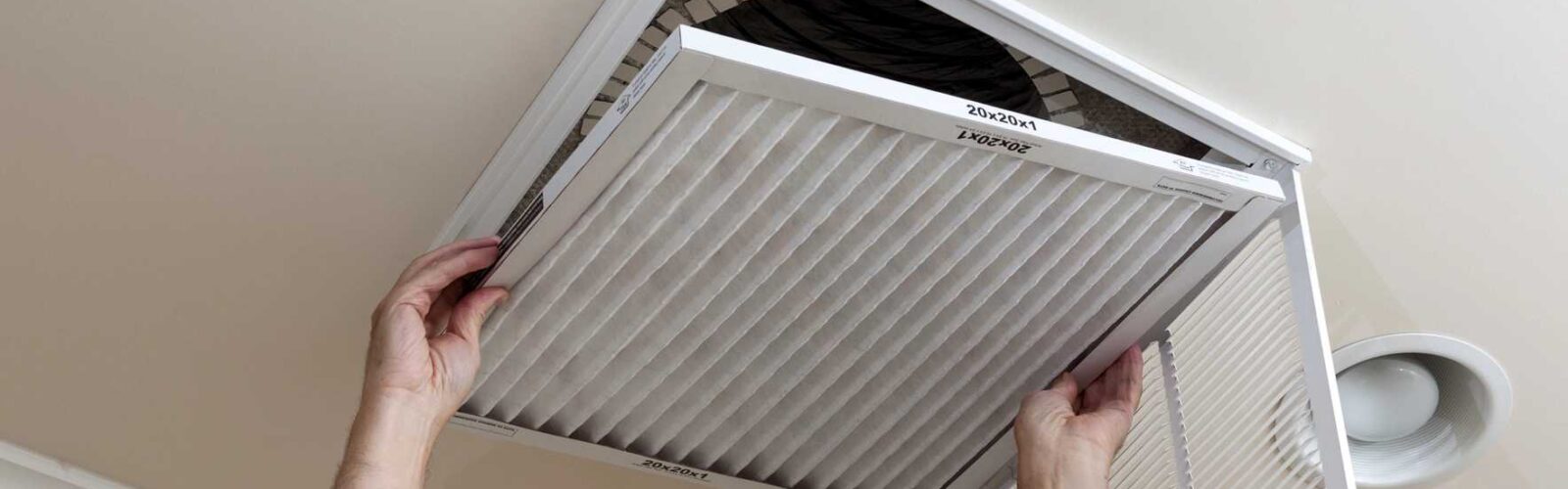 Close-up of a white air filter with pleats.